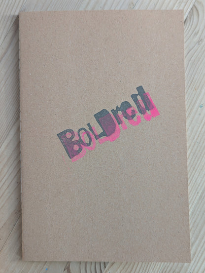 Brown A5 Notebook with brown blank paper with the BOLDred stamp in black and pink places on top of each other 